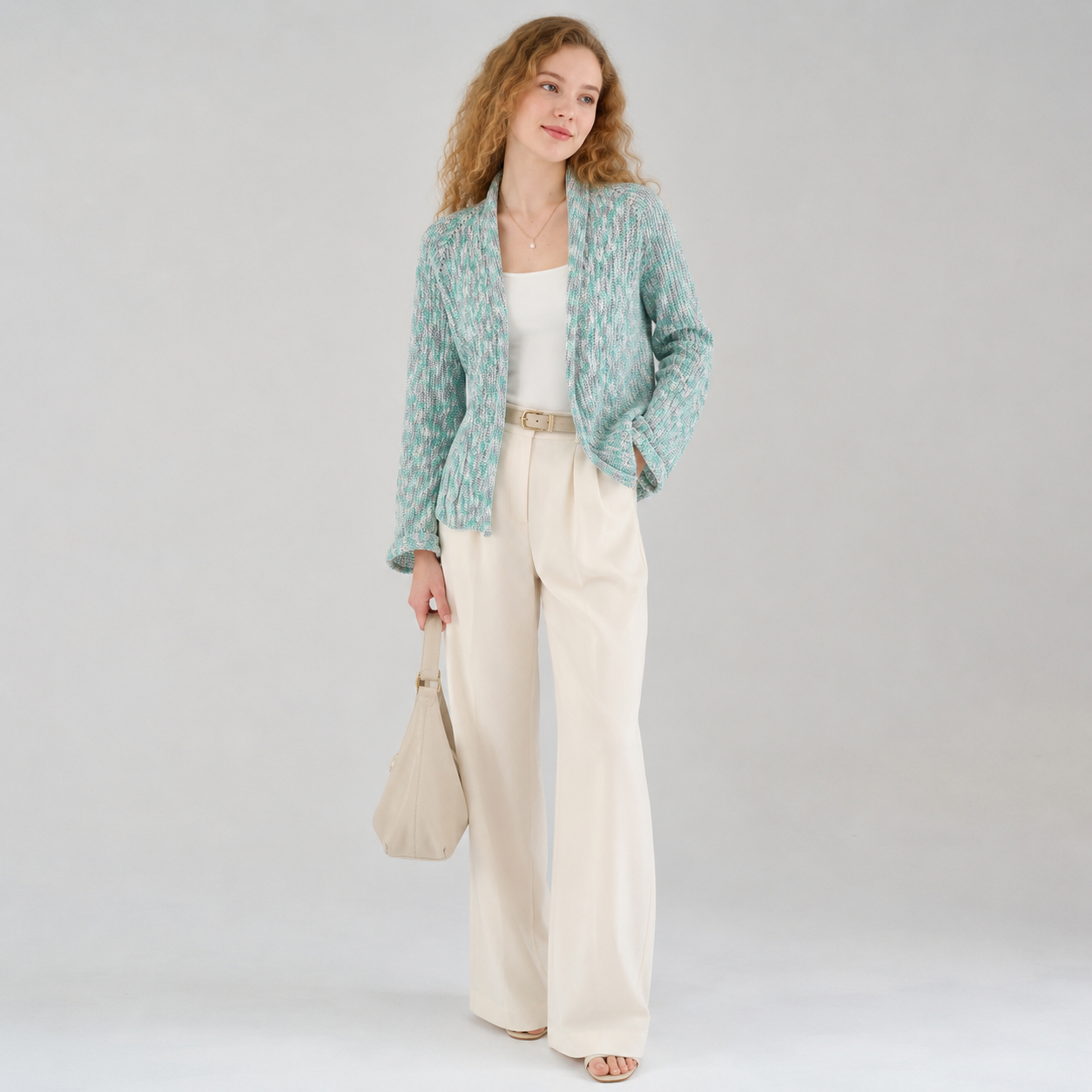 Handknitted mint green cardigan worn with cream wide-leg trousers — INESKA customer photo