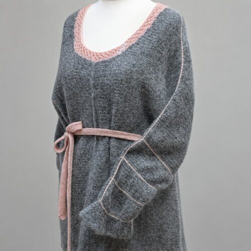 Handknitted grey merino alpaca raglan sweater with blush pink crochet trim and knitted belt, front view on dress form — INESKA Cloud Raglan Sweater