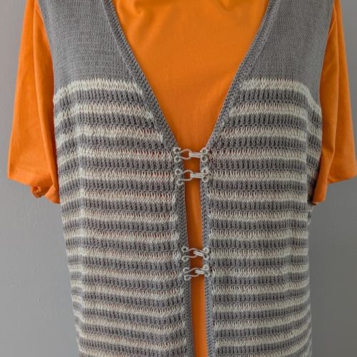 Close up of decorative hook clasps on handknitted linen vest, slow fashion detail