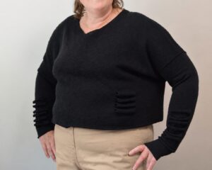 Woman wearing custom handknitted black cotton sweater with V-neck by INESKA, made to order