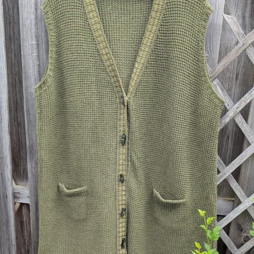 Olive green hand-knitted linen and merino wool vest, front view with V-neck and crocheted pockets