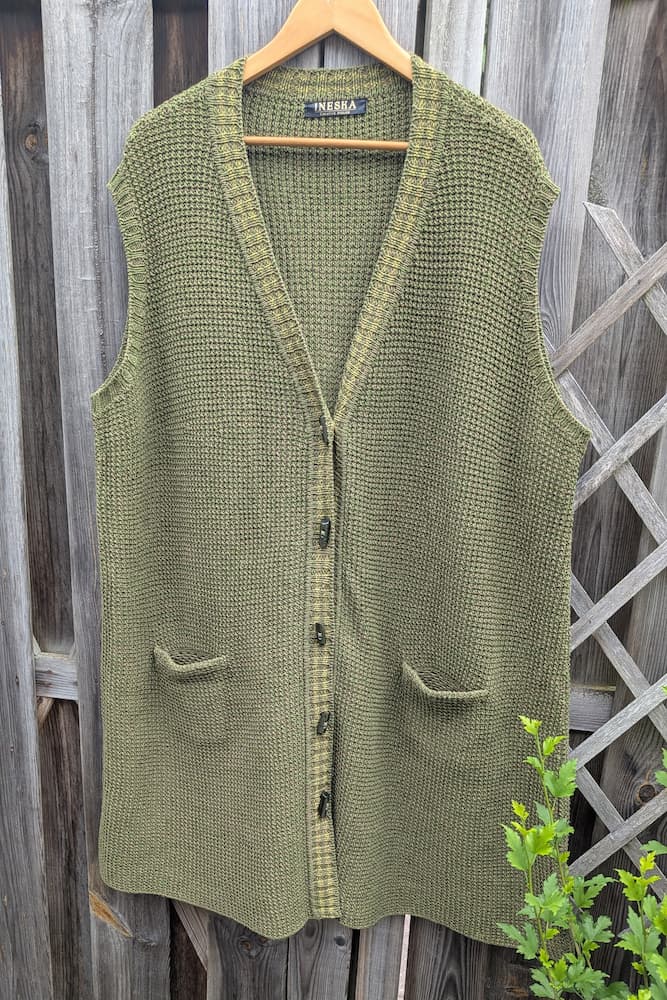 Olive green hand-knitted linen and merino wool vest, front view with V-neck and crocheted pockets