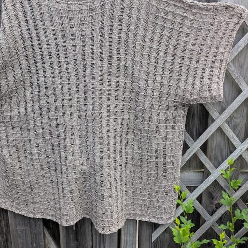 Full front view of the hemp knit tunic on a hanger, boxy silhouette with short sleeves, beige-brown mélange